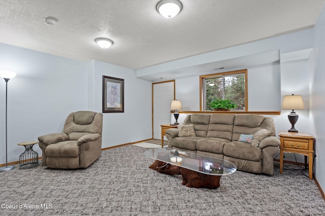 carpeted living room featuring a textured ceiling