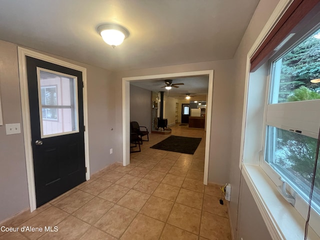 foyer entrance featuring ceiling fan and light tile patterned flooring