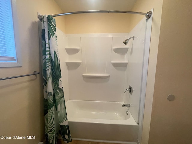 bathroom featuring shower / bathtub combination with curtain