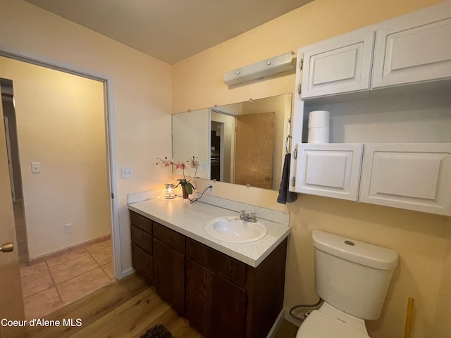 bathroom featuring hardwood / wood-style floors, vanity, and toilet