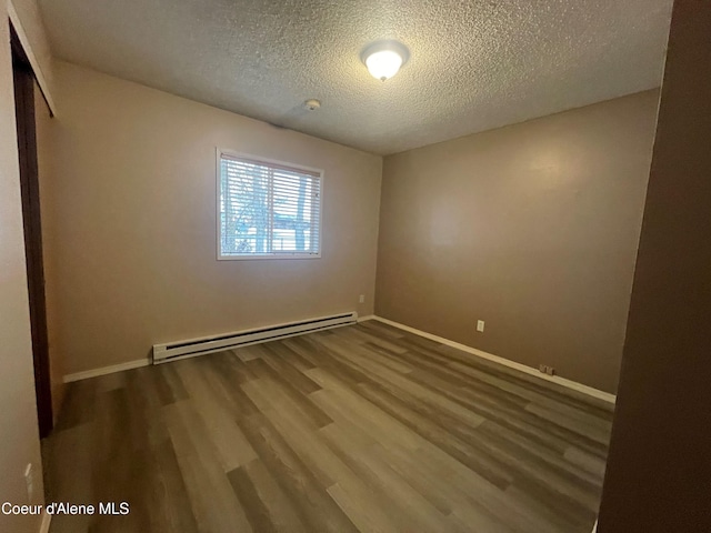 unfurnished bedroom with hardwood / wood-style floors, a closet, baseboard heating, and a textured ceiling
