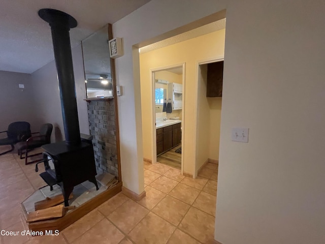 tiled living room featuring a wood stove
