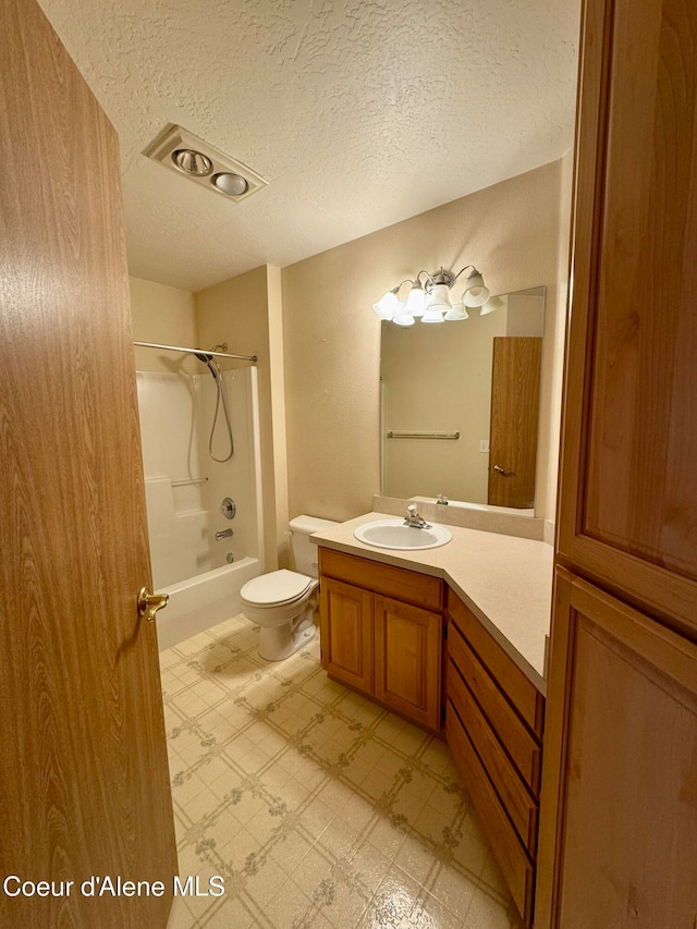 full bathroom with vanity, shower / tub combination, a textured ceiling, and toilet