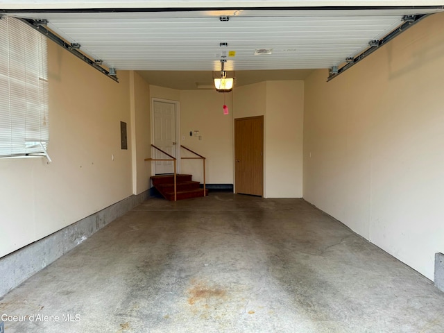 garage featuring electric panel and a garage door opener