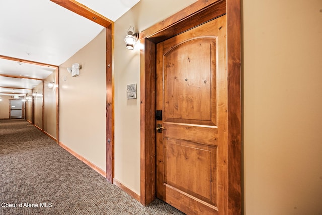 hallway featuring carpet floors and vaulted ceiling