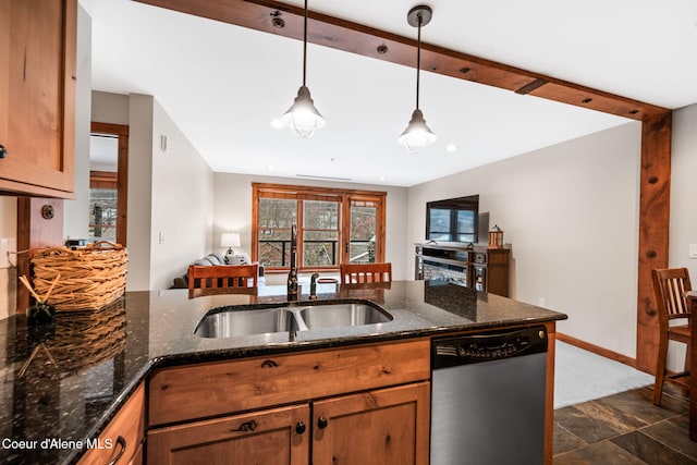 kitchen with kitchen peninsula, stainless steel dishwasher, sink, pendant lighting, and dark stone countertops