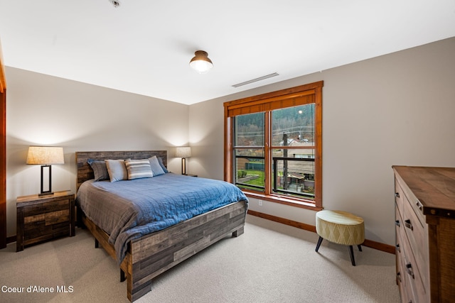 bedroom featuring light carpet