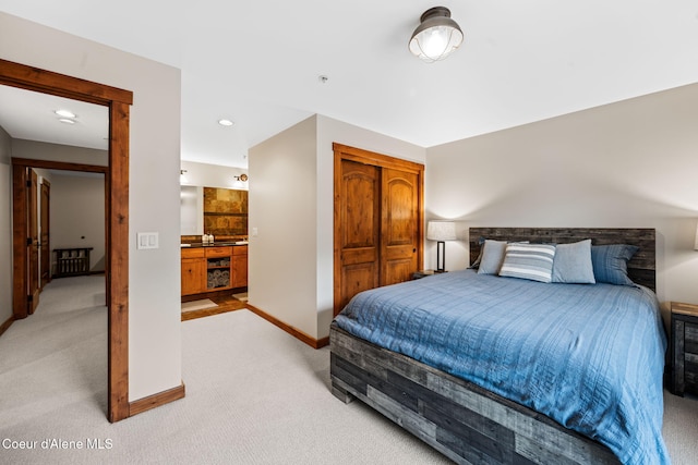 carpeted bedroom featuring ensuite bathroom