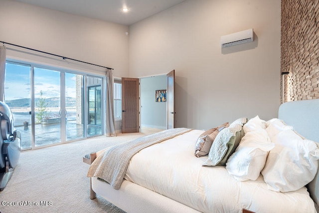 bedroom with light colored carpet, an AC wall unit, a high ceiling, and access to outside