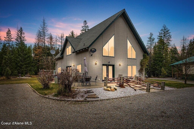 back house at dusk with a patio