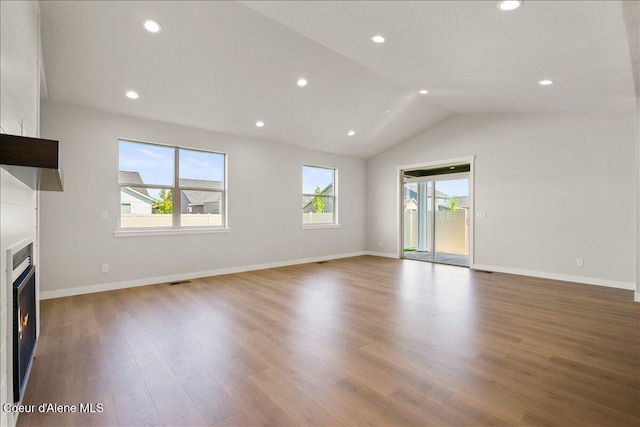 unfurnished living room featuring light hardwood / wood-style floors and lofted ceiling