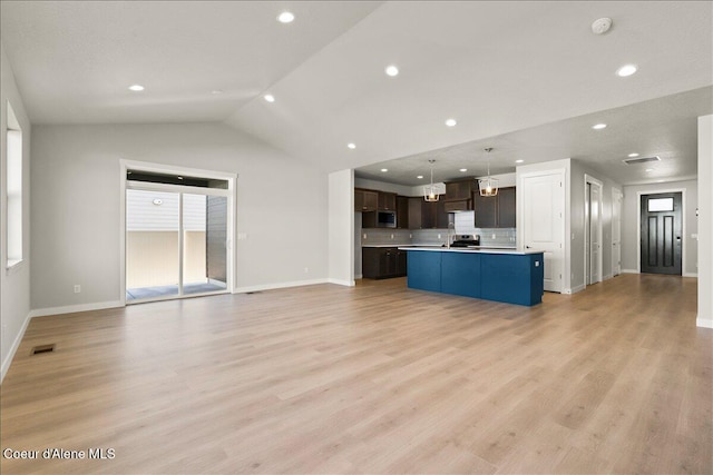 unfurnished living room featuring light wood-type flooring and lofted ceiling