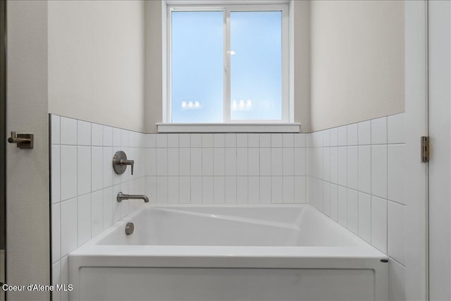 bathroom with a tub to relax in