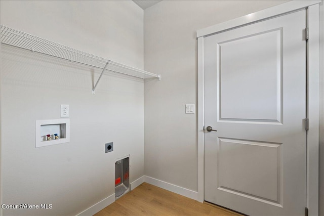 washroom featuring hookup for a washing machine, light wood-type flooring, and hookup for an electric dryer