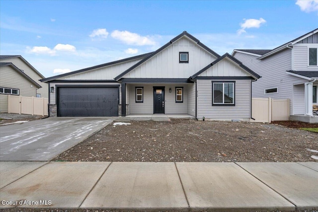 view of front facade with a garage, driveway, fence, a porch, and board and batten siding