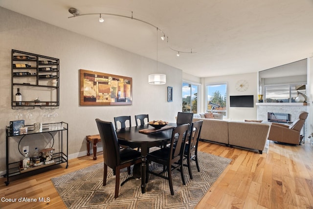 dining room featuring wood-type flooring and rail lighting