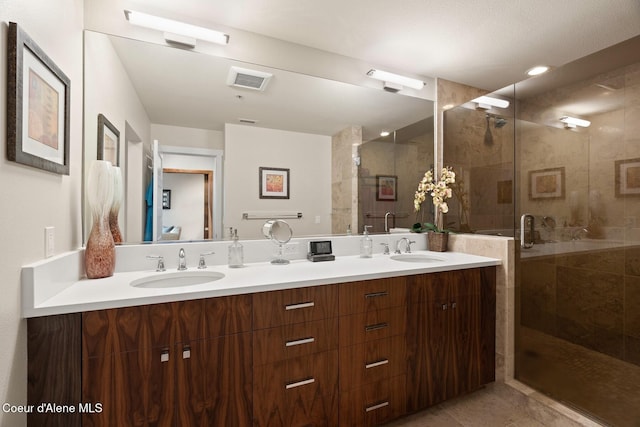 bathroom featuring vanity, tile patterned floors, and a shower with shower door