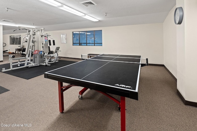 playroom featuring carpet and a textured ceiling