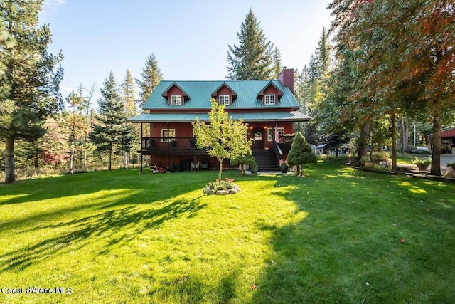 view of front of house with a wooden deck and a front yard