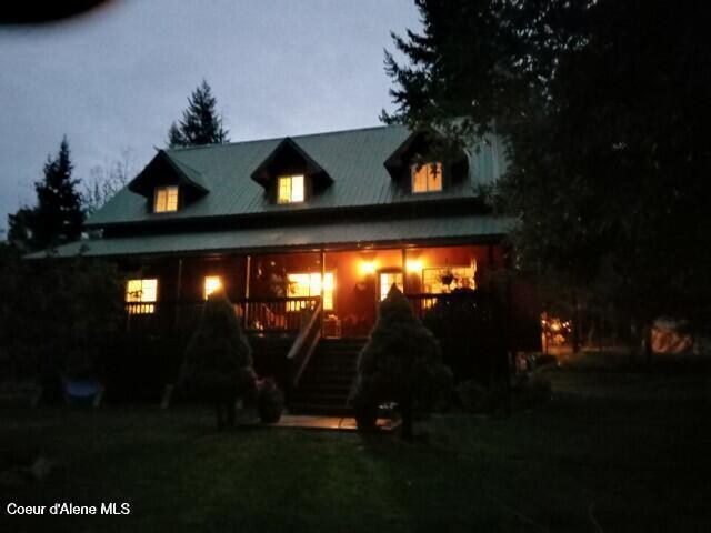 rear view of property featuring a porch