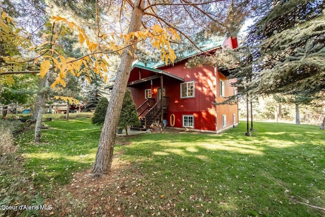 rear view of property featuring a yard