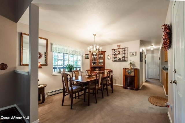 dining room featuring carpet, a baseboard radiator, and an inviting chandelier