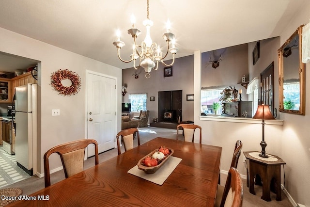 dining space with a notable chandelier and carpet floors