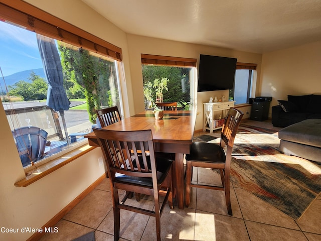 tiled dining room with a mountain view