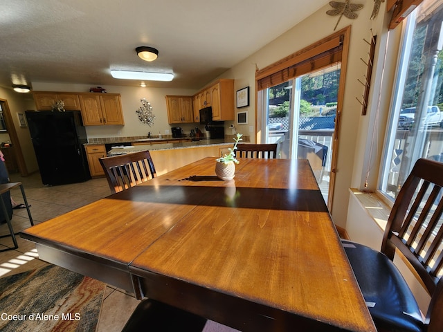 dining room featuring light tile patterned floors and sink