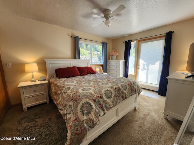 bedroom featuring ceiling fan, light carpet, and a textured ceiling