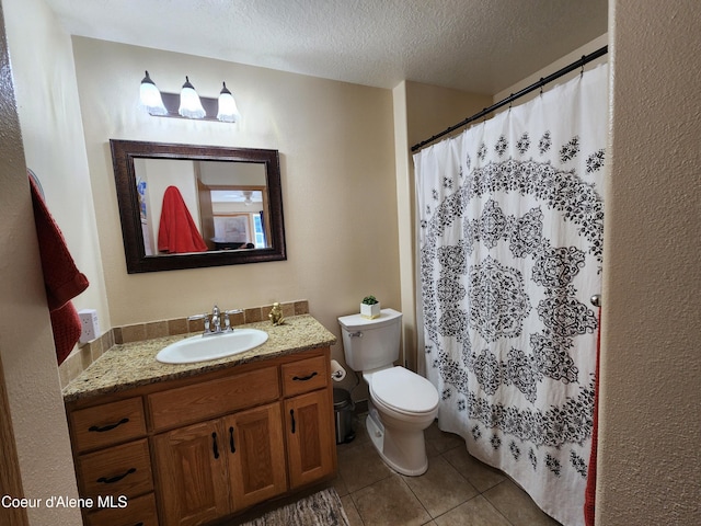 bathroom featuring walk in shower, tile patterned floors, a textured ceiling, toilet, and vanity