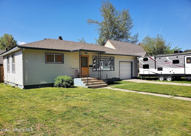 view of front facade with a front yard and a garage