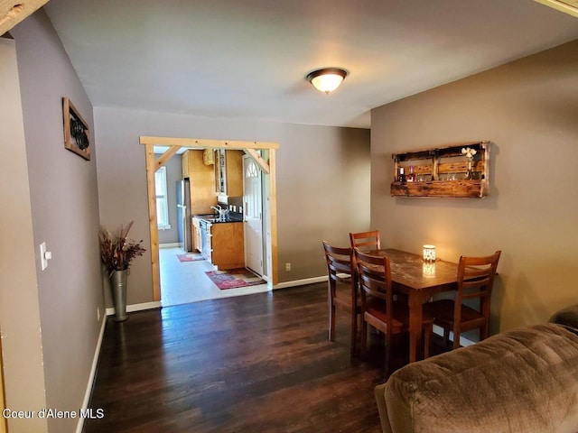 dining room with sink and dark hardwood / wood-style floors