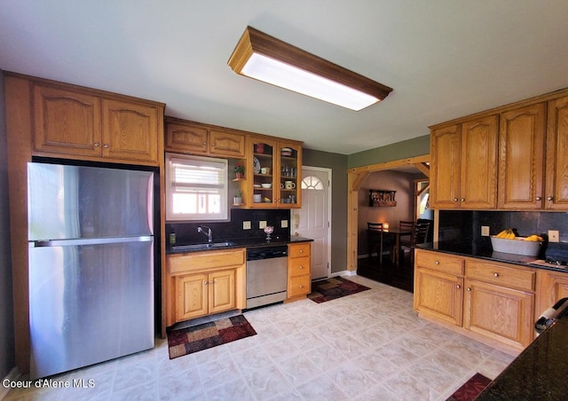 kitchen featuring decorative backsplash, sink, and stainless steel appliances