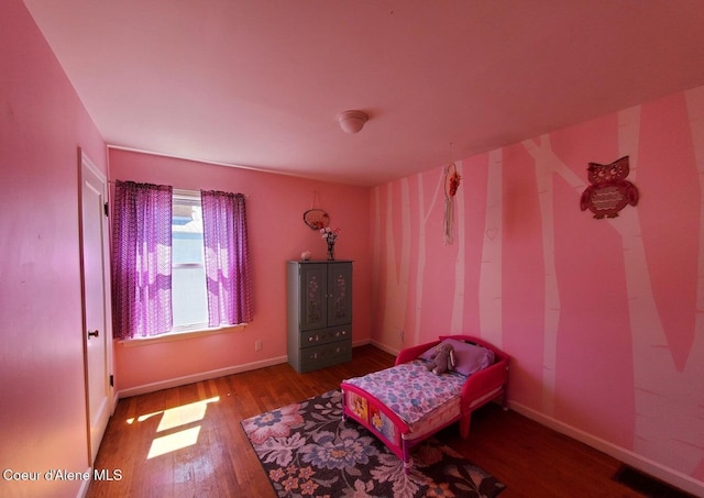 bedroom with wood-type flooring