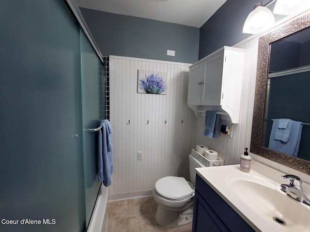 bathroom with an enclosed shower, vanity, and toilet