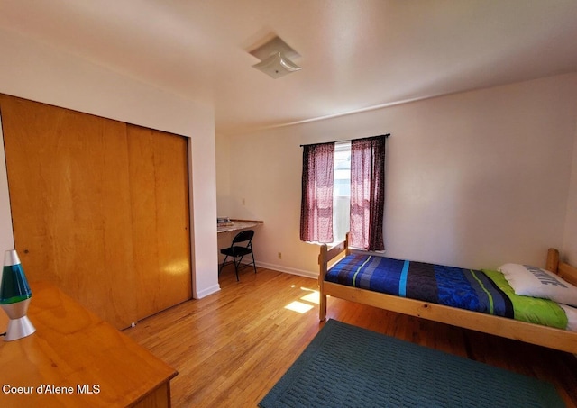 unfurnished bedroom with a closet and light hardwood / wood-style floors