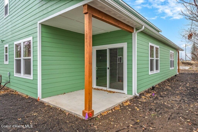 view of property exterior with a patio area