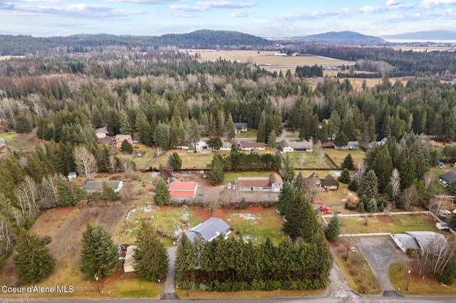 11673 N Boyer Rd, Sandpoint, ID 83864 - aerial overview of property's location featuring a mountain backdrop and a heavily wooded area