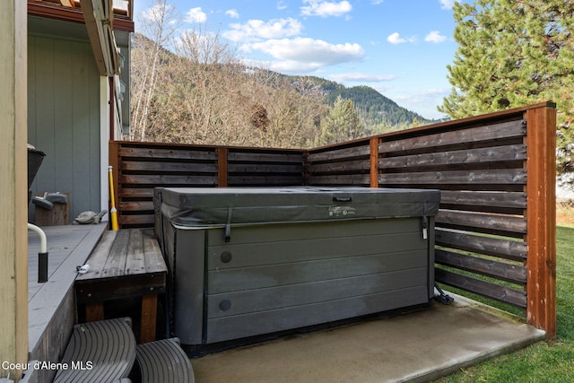 11673 N Boyer Rd, Sandpoint, ID 83864 - view of patio with a hot tub and a mountain view