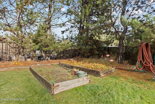 11673 N Boyer Rd, Sandpoint, ID 83864 - view of green lawn featuring a vegetable garden