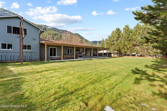 11673 N Boyer Rd, Sandpoint, ID 83864 - rear view of property with a mountain view and a yard