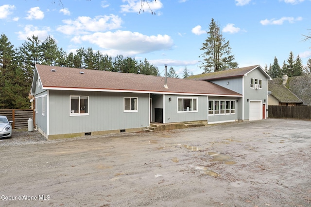 rear view of house with a garage