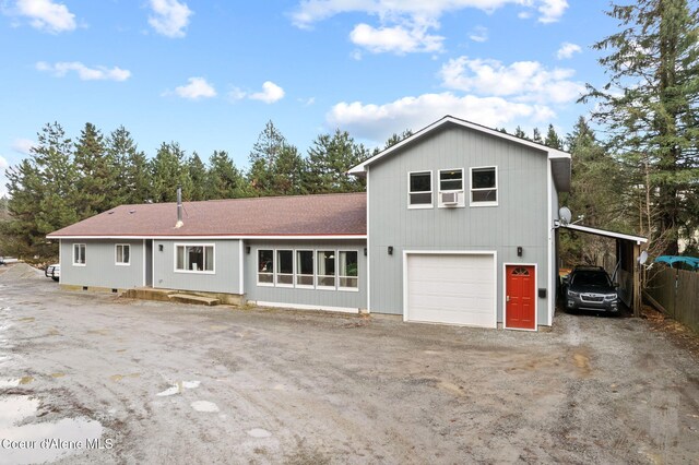 11673 N Boyer Rd, Sandpoint, ID 83864 - view of front of house featuring a carport, dirt driveway, and a shingled roof