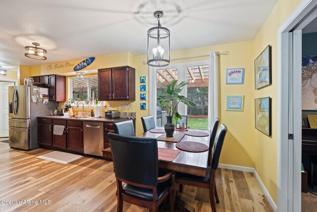 11673 N Boyer Rd, Sandpoint, ID 83864 - dining space featuring light wood-style flooring, healthy amount of natural light, and baseboards