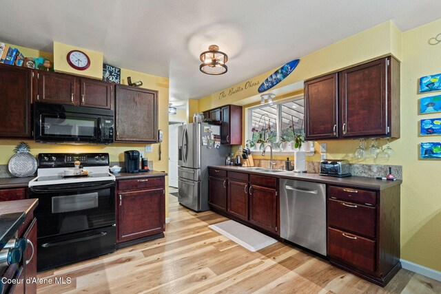 11673 N Boyer Rd, Sandpoint, ID 83864 - kitchen featuring stainless steel appliances, a sink, and light wood finished floors