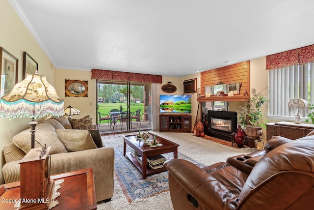 living room featuring a fireplace, light carpet, and ornamental molding