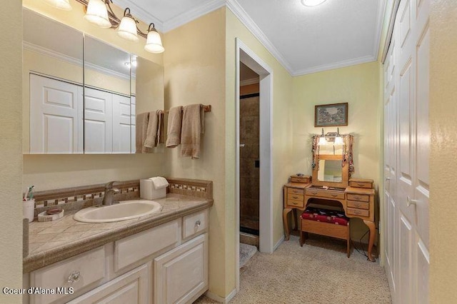 bathroom with vanity, a shower with shower door, and crown molding