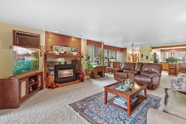 living room with light colored carpet, a fireplace, and a wall unit AC