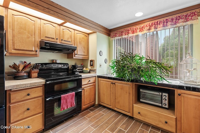 kitchen with electric range, dark hardwood / wood-style flooring, and tile counters